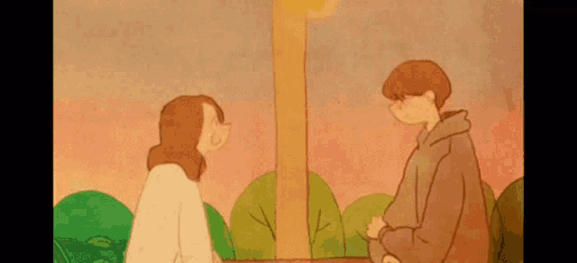 a man and a woman are standing next to each other in a park .