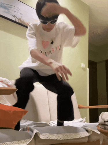 a person wearing sunglasses and a shirt that says i love you
