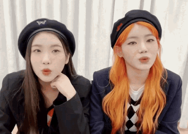 two girls wearing beret hats with a butterfly on them