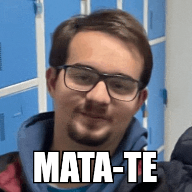 a man wearing glasses and a beard is standing in front of blue lockers with the words mata-te written on his face