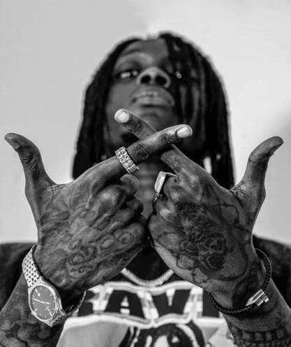 a black and white photo of a man wearing a watch and a shirt that says raw