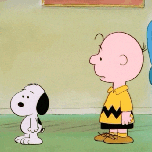 charlie brown and snoopy standing next to each other