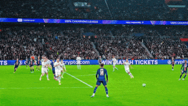 soccer players on a field with uefa champions league banners
