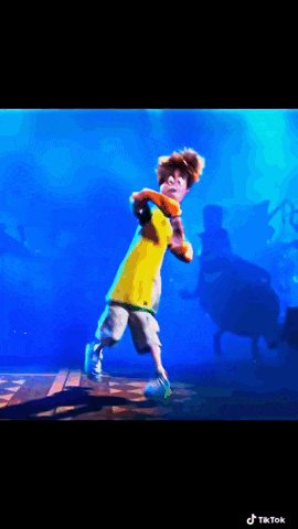 a boy in a yellow shirt is dancing on a stage in front of a blue background .