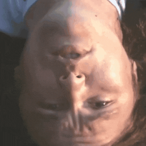 a close up of a person 's face upside down with their eyes closed