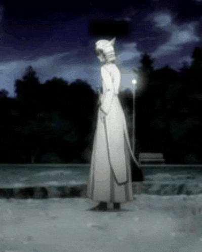 a woman in a white dress is standing in the snow holding a leash .