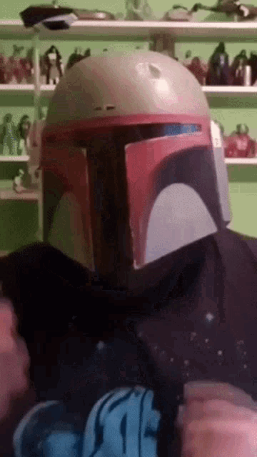 a person wearing a boba fett helmet and a star wars t-shirt