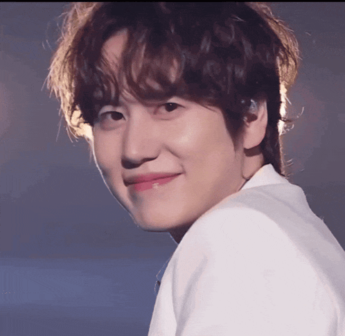 a close up of a young man 's face with a smile on his face