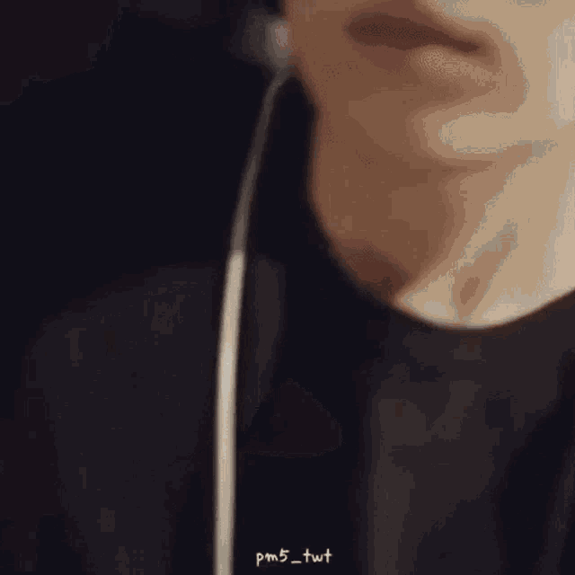 a close up of a person 's face with headphones on .