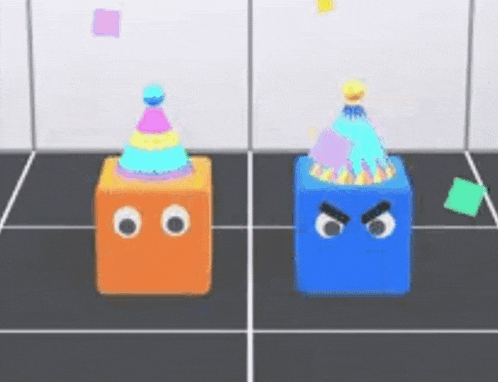 two blocks with faces and party hats on them are standing next to each other on a tiled floor .