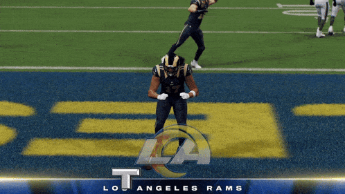 a football player for the los angeles rams celebrates a touchdown