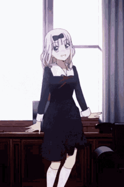 a girl in a black dress and white socks stands in front of a window