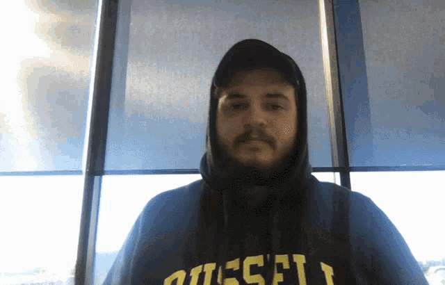 a man wearing a hoodie with diesel on it