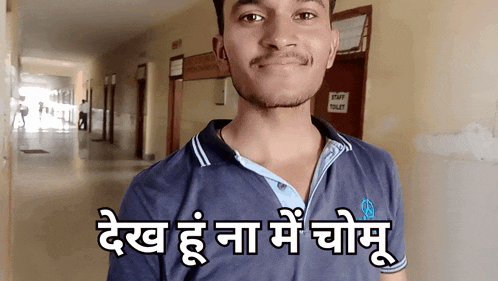 a man wearing a blue shirt with the words " dev " on the front of it