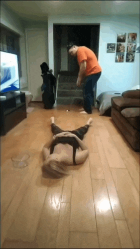 a woman is laying on the floor in a living room