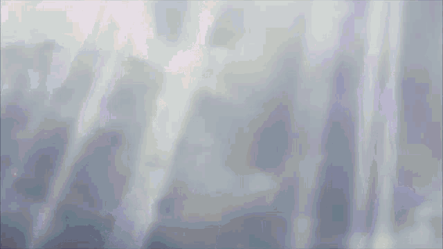 a gray background with a few rays of light coming through it