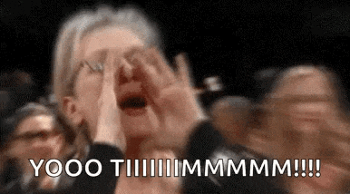 a woman is screaming in a crowd of people .