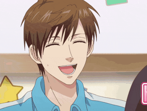 a man in a blue shirt is smiling with his tongue hanging out