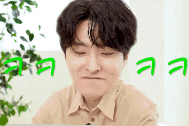 a man making a funny face with green letters behind him that say aaa