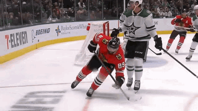 a hockey game is being played in front of a boeing and 7 eleven advertisement