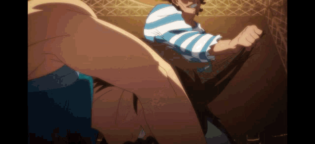a man in a blue and white striped shirt is holding another man 's leg