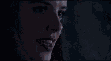 a person is holding a ball in a dark room .