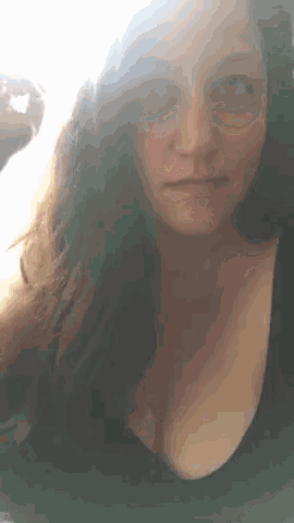 a close up of a woman 's face and breasts