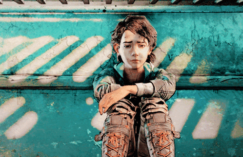 a girl with a sad look on her face sits in front of a wall