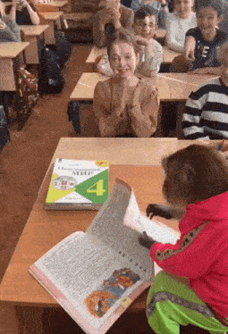a monkey sits at a desk reading a book with the number 4 on the front