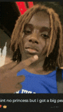 a man with dreadlocks is wearing a blue shirt that says trtc
