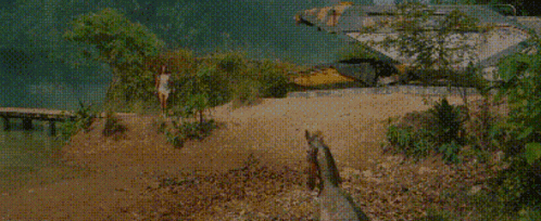 a woman is walking along a beach next to a body of water .