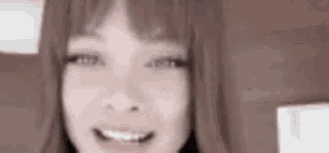a close up of a woman 's face with a smile on it .