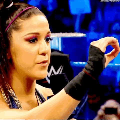 a female wrestler is wearing a headband and wrist wraps