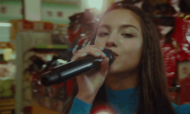 a woman sings into a microphone in a store