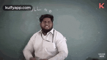 a man with a beard is standing in front of a chalkboard .