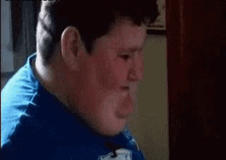 a close up of a man 's face in a blue shirt .