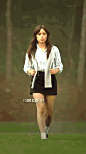 a woman in a white dress is standing in front of a mirror with the words " rooh kad ke le " on the bottom