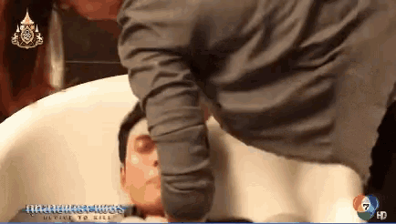 a man in a bathtub with the number 7 on the bottom right