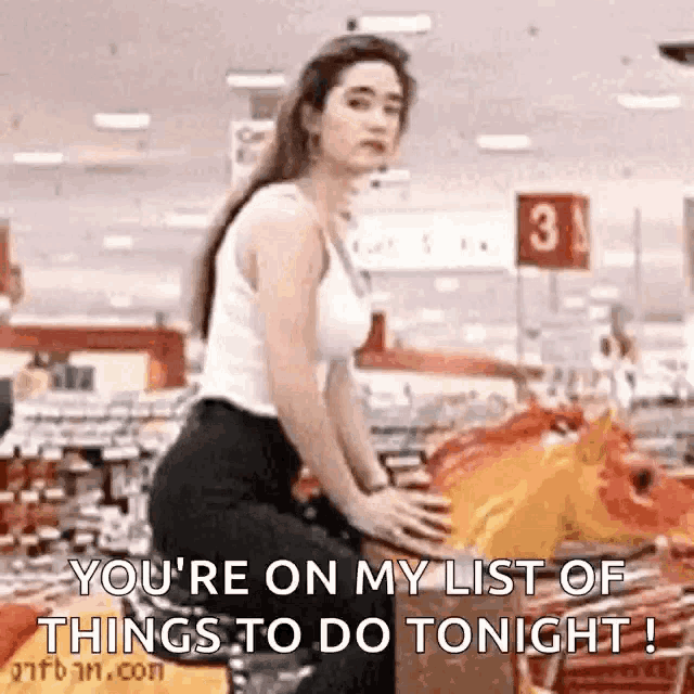 a woman is riding a rocking horse in a grocery store .