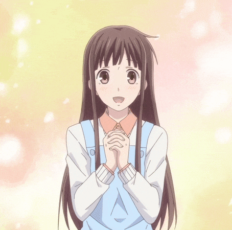 a girl with long hair is smiling with her hands folded in front of her face