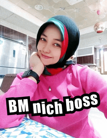 a woman in a pink sweater with the words bm nich boss on the top
