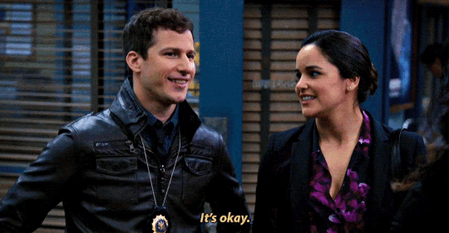 a man and a woman are standing next to each other and the man says " it 's okay "
