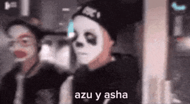 a man wearing a panda mask and a hat is standing next to another man wearing a panda mask .