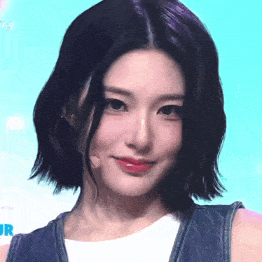 a close up of a woman 's face with the word jr visible in the background