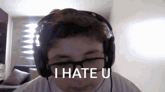 a person wearing headphones and glasses says i hate u