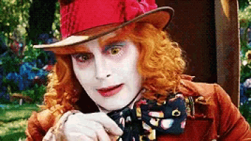 the mad hatter from alice in wonderland has red hair and white face paint