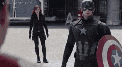 captain america and black widow are standing next to each other and talking to each other .