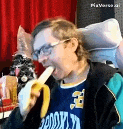 a man wearing glasses is eating a banana while wearing a brooklyn jersey .