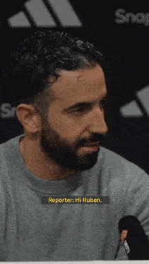 a man with a beard is being interviewed by a reporter named ruben