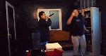a man singing into a microphone in a room